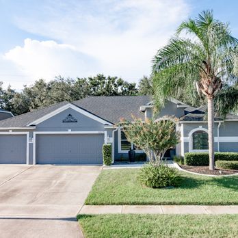 JSJ Painting - the front of a home with palm trees in the front yard - Flooring Near Me - Orlando, Florida JSJ Painting - the front of a home with palm trees in the front yard - Flooring Near Me - Orlando, Florida