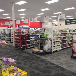 Follow the black carpet tiles to the Pharmacy in the back of the store. Follow the black carpet tiles to the Pharmacy in the back of the store.