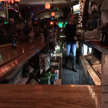 Monopole Restaurant - a woman standing at the bar - Pizza Near Me - Plattsburgh, New York