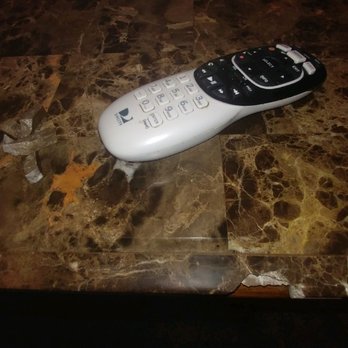 Patriot Stone Restoration Inc - Damage to marble bar countertop edge below remote - Flooring Near Me