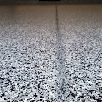 Garage Floor Epoxy - Close-up of a full flake epoxy garage floor with a durable polyaspartic topcoat. - Flooring Near Me - Simi Valley, California Garage Floor Epoxy - Close-up of a full flake epoxy garage floor with a durable polyaspartic topcoat. - Flooring Near Me - Simi Valley, California