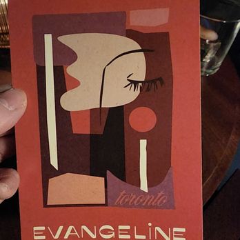 Evangeline - a person holding up a poster - Cocktail Bars Near Me - Toronto, Ontario
