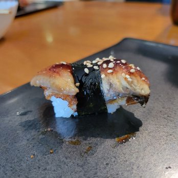 Sushi Akio - a piece of sushi on a black plate - Japanese Near Me - Forest Hills, New York Sushi Akio - a piece of sushi on a black plate - Japanese Near Me - Forest Hills, New York