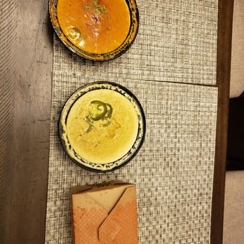 Tarka Indian Kitchen - a bowl of soup and a plate of crackers - Indian Near Me - Houston, Texas