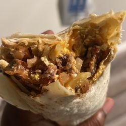 Big Burrito Mexican Fast Food - Breakfast Bacon Burrito - they are not stingy on the bacon ! There is onions, hash browns and cheddar cheese. just choose your protein