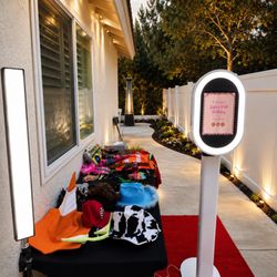 Modern photobooth setup with red carpet, props, and instant sharing for Inland Empire celebrations.