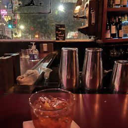 a drink in a glass on a table a drink in a glass on a table