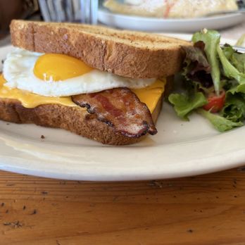 Blue Lava Cafe - Breakfast sandwich with bacon as the protein sunny side up greens on the side - Cafes Near Me - Capitola, California