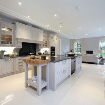 Absolute Floors - A fresh, open kitchen design brought to life with sleek light tile floors. Another flawless installation by Absolute Floors - Flooring Near Me - Nashua, New Hampshire