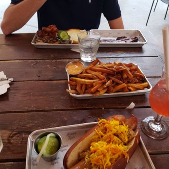 Kaiser Tiger - Tiki Time drink, cheesy brat, small fries with Cajun remoulade, Kaiser Royale, and housemade cracked pepper bacon - New American Near Me - Chicago, Illinois Kaiser Tiger - Tiki Time drink, cheesy brat, small fries with Cajun remoulade, Kaiser Royale, and housemade cracked pepper bacon - New American Near Me - Chicago, Illinois