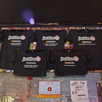 Jackbar - t - shirts hanging on a brick wall - Bars Near Me - Brooklyn, New York