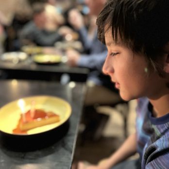 La Marcha Tapas Bar - Birthday candle on the cheesecake flan for the birthday boy - Spanish Near Me - Berkeley, California