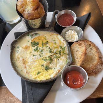 Cup Cafe - Cast Iron Baked Eggs: over hard eggs, ham, leeks, shallots, gruyère cheese, cream, fines herbes, breakfast potatoes, toast. So good! - New American Near Me - Tucson, Arizona