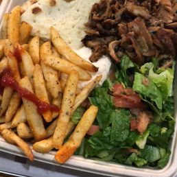Fresh fries  gyro cucumbers tomatoes salad  onion