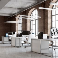 Stars and Stripes Lighting - Commercial LED linear pendant lights illuminating an open office workspace with modern desks and computer stations