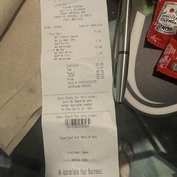 Carl's Jr - a receipt and a pen on a table - Fast Food Near Me - Santa Fe Springs, California