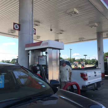 Flying J Travel Center - a man filling up his car at a gas station - Gas Stations Near Me - Orange, Texas