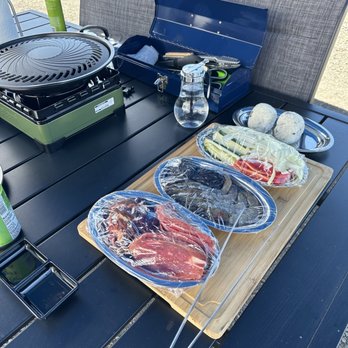 Kona Barbeque - a table with a grill, plates of food, and a bottle of ketchup - Barbeque Near Me - Kailua-Kona, Hawaii Kona Barbeque - a table with a grill, plates of food, and a bottle of ketchup - Barbeque Near Me - Kailua-Kona, Hawaii