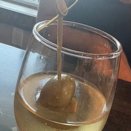 Dirty martini served in a wine glass Dirty martini served in a wine glass