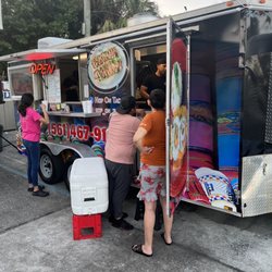 The food truck sits on the side of the mobile gas station