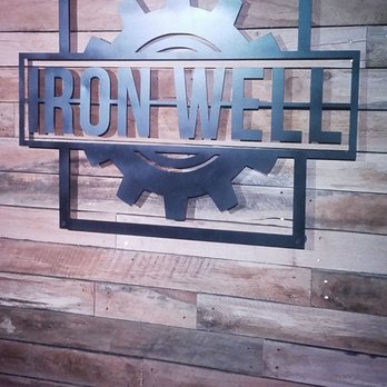 Iron Well - a sign on a wooden wall - Bars Near Me - Grand Rapids, Michigan Iron Well - a sign on a wooden wall - Bars Near Me - Grand Rapids, Michigan