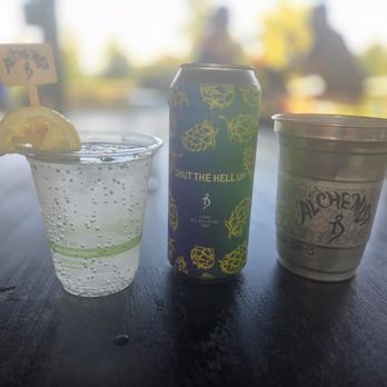 The Alchemist - The drinks we got. Depicted from left to right is a vodka seltzer, a Shut the Hell Up light lager can, and a Heady Topper on draft. - Breweries Near Me - Stowe, Vermont The Alchemist - The drinks we got. Depicted from left to right is a vodka seltzer, a Shut the Hell Up light lager can, and a Heady Topper on draft. - Breweries Near Me - Stowe, Vermont