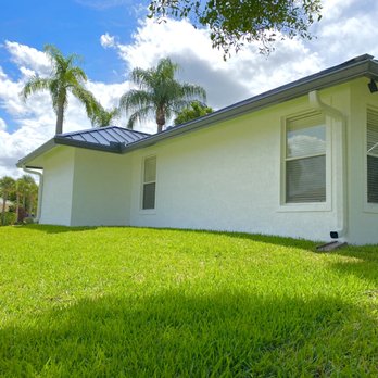 Ocean1Gutters - 7in dark bronze gutters to match metal roof and handle the amount of water these metal roofs bring off 4x5 downspouts to keep gutters dry - Gutter Services Near Me - Boynton Beach, Florida