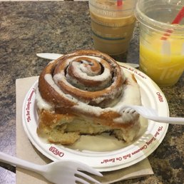 a cinnamon roll on a paper plate
