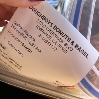 Doughboy Donuts & Bagel - a hand holding a bagel - Donuts Near Me - Torrance, California