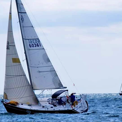 Sailing With Julie - Our sailboat, Julianna, gracefully gliding across the blue waters of Lake Michigan, representing the quintessential boating experience.
