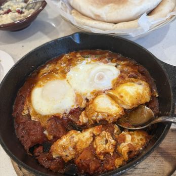 Zaatar Lebanese Grill - Shakshuka. Three eggs in a spicy tomato sauce. The dish arrived sizzling and was the perfect brunch meal. - Lebanese Near Me - San Antonio, Texas Zaatar Lebanese Grill - Shakshuka. Three eggs in a spicy tomato sauce. The dish arrived sizzling and was the perfect brunch meal. - Lebanese Near Me - San Antonio, Texas