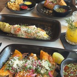 Birria tacos, street corn, French fries, and birria burrito Birria tacos, street corn, French fries, and birria burrito