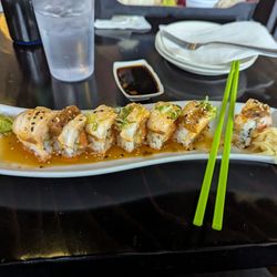 QQ Sushi & Kitchen - Waikiki roll spicy tuna cucumber and pineapple topped with seared white fish and ginger ponzu