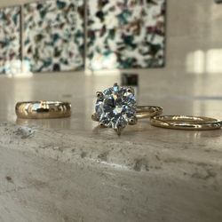 His, her's and her's.  Classic solitaire engagement ring and wedding band set.