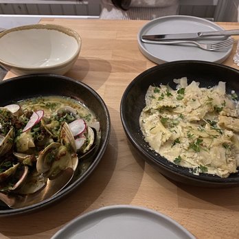 Nina May - Curried Little Neck Clams (left) and Cacio Pepe Agnolotti of Carmelized Onion and Ricotta Cheese (right). - New American Near Me - Washington, DC, District of Columbia Nina May - Curried Little Neck Clams (left) and Cacio Pepe Agnolotti of Carmelized Onion and Ricotta Cheese (right). - New American Near Me - Washington, DC, District of Columbia