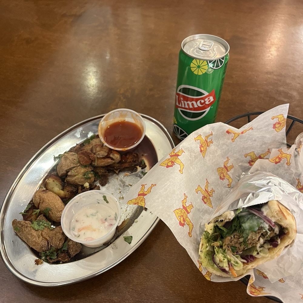 Smashed potato app, lamb wrap, and Limca drink. Smashed potato app, lamb wrap, and Limca drink.