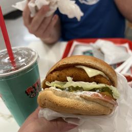 a hand holding a sandwich