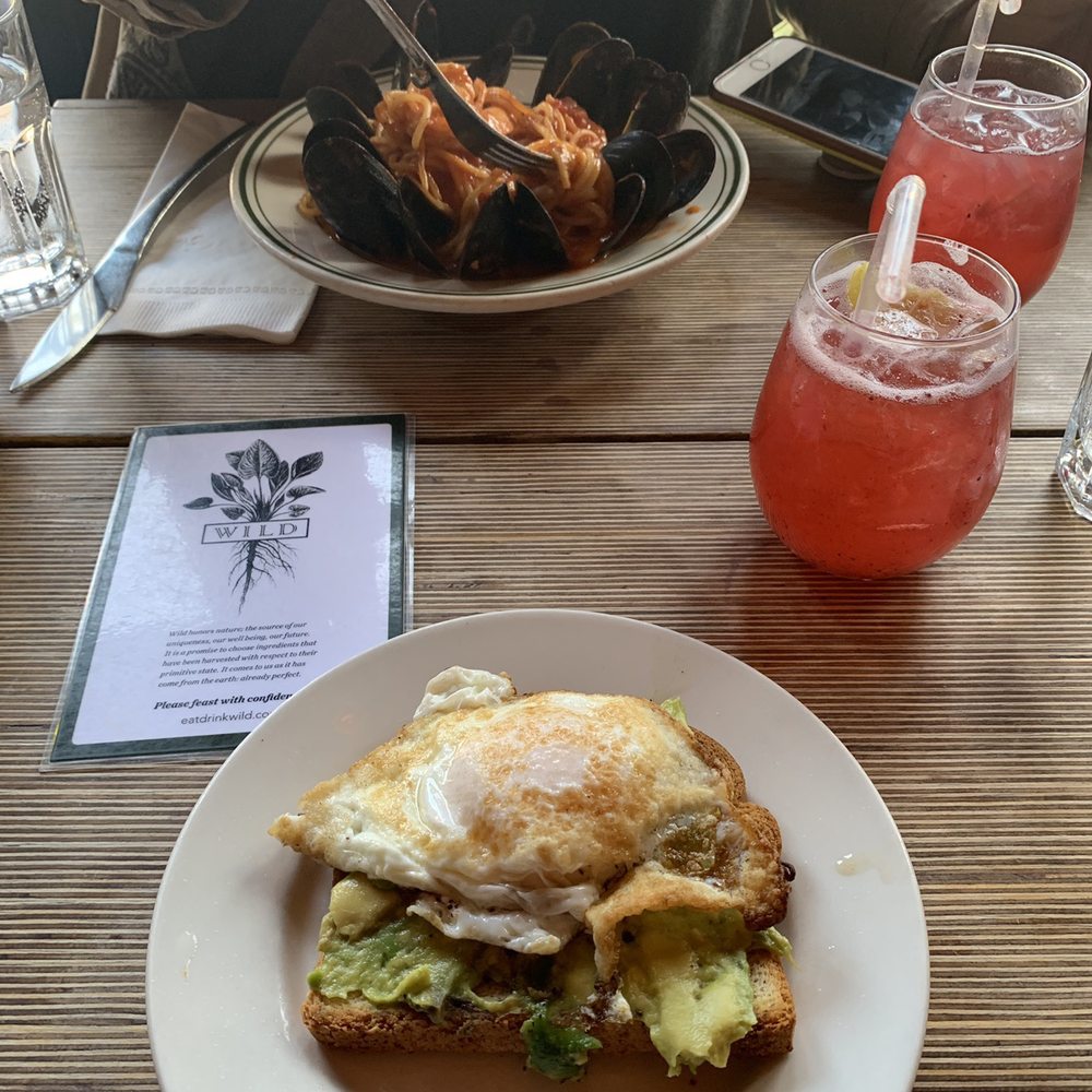 WILD - Beautiful avocado toast topped with a delicious over done egg. Simply delicious - New American Near Me - New York, New York WILD - Beautiful avocado toast topped with a delicious over done egg. Simply delicious - New American Near Me - New York, New York