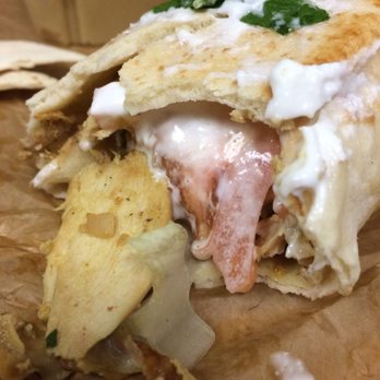 Shawarmar - Shawarmar Deluxe Wrap. Marinated chicken, creamy garlic sauce, pickles, lettuce, tomato, parsley, French fries, all inside a pita wrap. - Falafel Near Me - Kansas City, Missouri Shawarmar - Shawarmar Deluxe Wrap. Marinated chicken, creamy garlic sauce, pickles, lettuce, tomato, parsley, French fries, all inside a pita wrap. - Falafel Near Me - Kansas City, Missouri