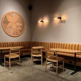a corner seating area with a clock on the wall