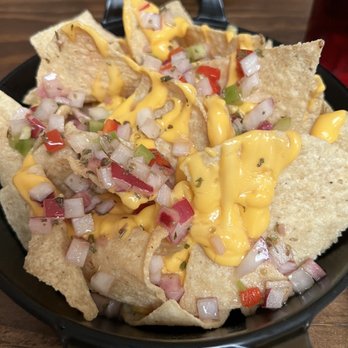 Clerico - a plate of nachos with cheese and onions - Argentine Near Me - Killeen, Texas Clerico - a plate of nachos with cheese and onions - Argentine Near Me - Killeen, Texas
