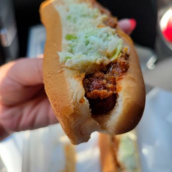 Pepperoni Grill - a hand holding a chili dog - Sandwiches Near Me - Charleston, West Virginia Pepperoni Grill - a hand holding a chili dog - Sandwiches Near Me - Charleston, West Virginia