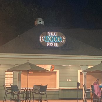 The Paddock Grill - people sitting at tables by the pool - Bars Near Me - Lake Buena Vista, Florida