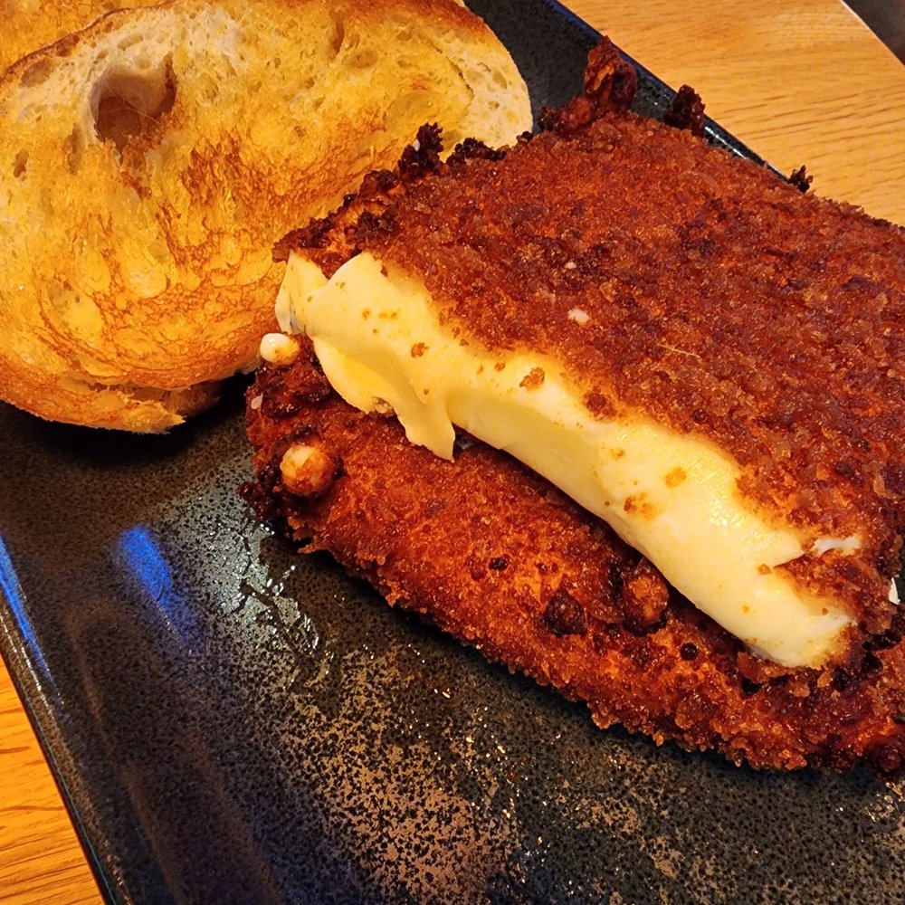 The Operators Club - Mozzarella cheese block with bread - Sports Bars Near Me - Dallas, Texas The Operators Club - Mozzarella cheese block with bread - Sports Bars Near Me - Dallas, Texas