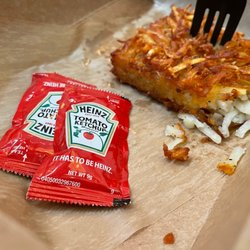 Delicious hash browns with my favorite brand of ketchup!