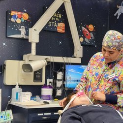 Starry Skies Dental - My son smiling n had the control in his hand. We had the space room but each room is a different theme! Loved it
