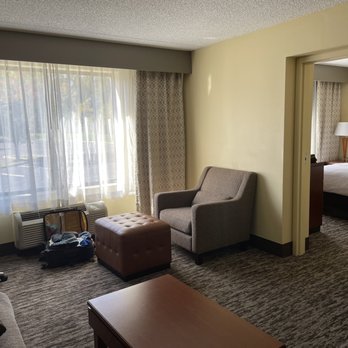 DoubleTree by Hilton Hotel Princeton - Living room and doorway to bedroom - Hotels Near Me - Princeton, New Jersey DoubleTree by Hilton Hotel Princeton - Living room and doorway to bedroom - Hotels Near Me - Princeton, New Jersey