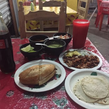 El Carboncito - Steak torta and a plate of al pastor tacos with flour tortillas, sauces, limes and salsa - Tacos Near Me - Tulum, ROO El Carboncito - Steak torta and a plate of al pastor tacos with flour tortillas, sauces, limes and salsa - Tacos Near Me - Tulum, ROO