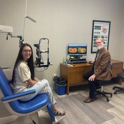 Dr. Chism sitting with patient.
