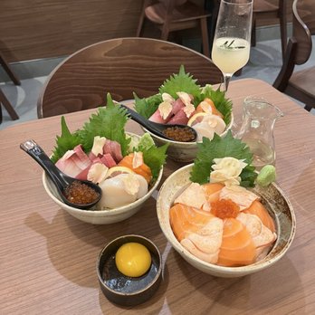 Tomoni - Two Chirashi Donburi, One Salmon Donburi w/ the raw egg on the side. I added to the rice of my chirashi bowl - Japanese Near Me - Woodside, New York